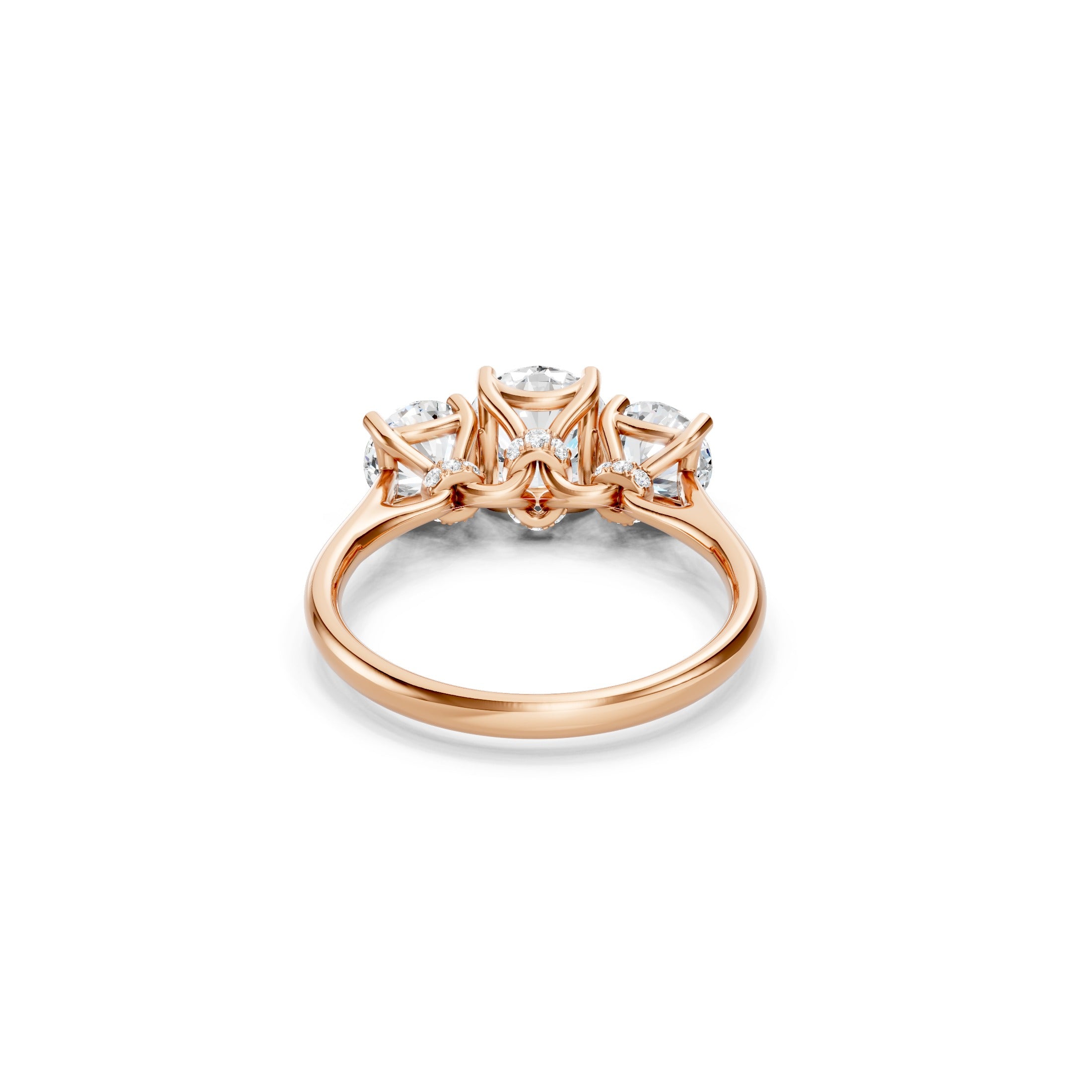 rose gold three stone engagement ring highlighting the open gallery, decorative diamond baskets, secure prong settings, and smooth polished band.