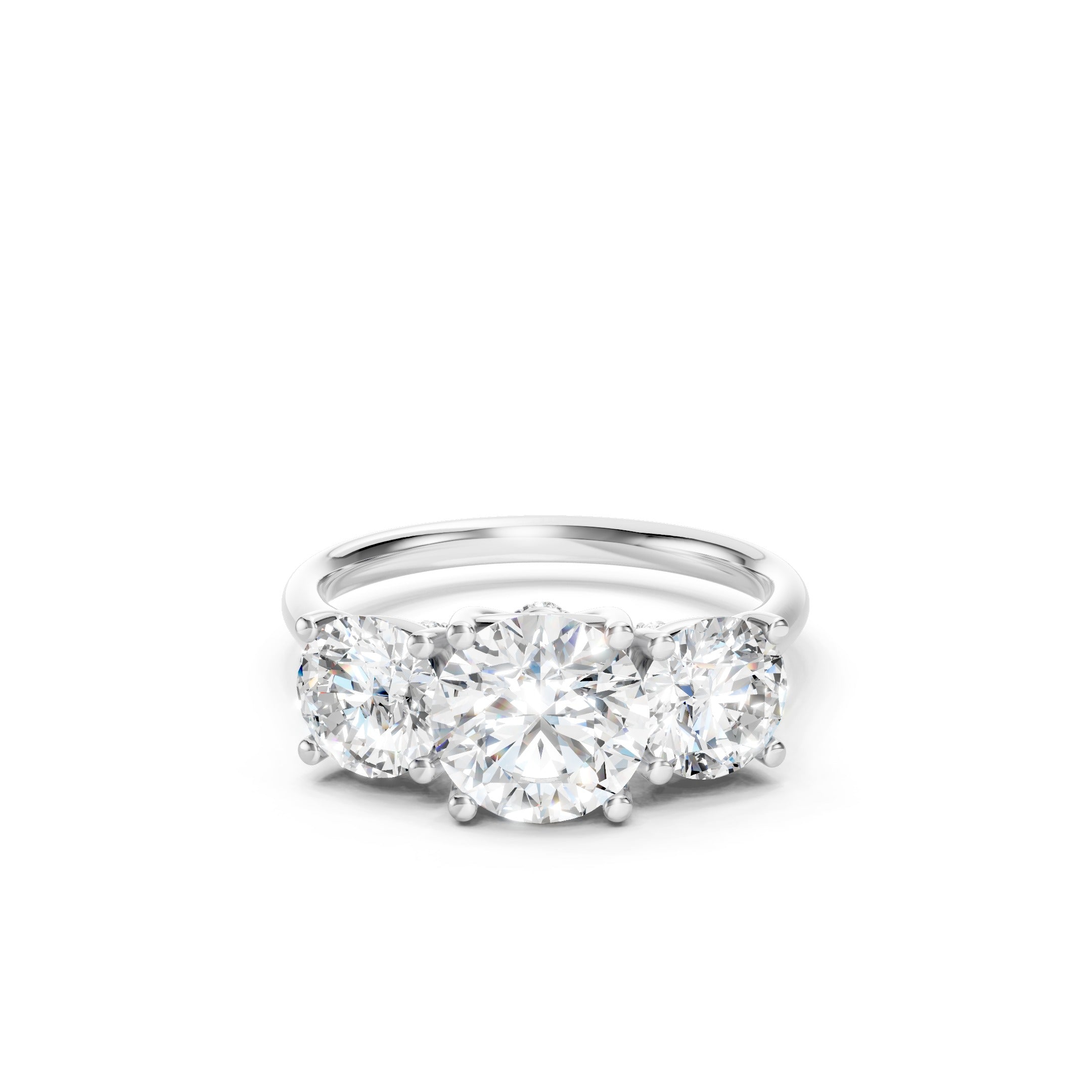 White gold three stone lab grown diamond engagement ring featuring a round cut center diamond, two matching round side diamonds, and a classic prong setting.