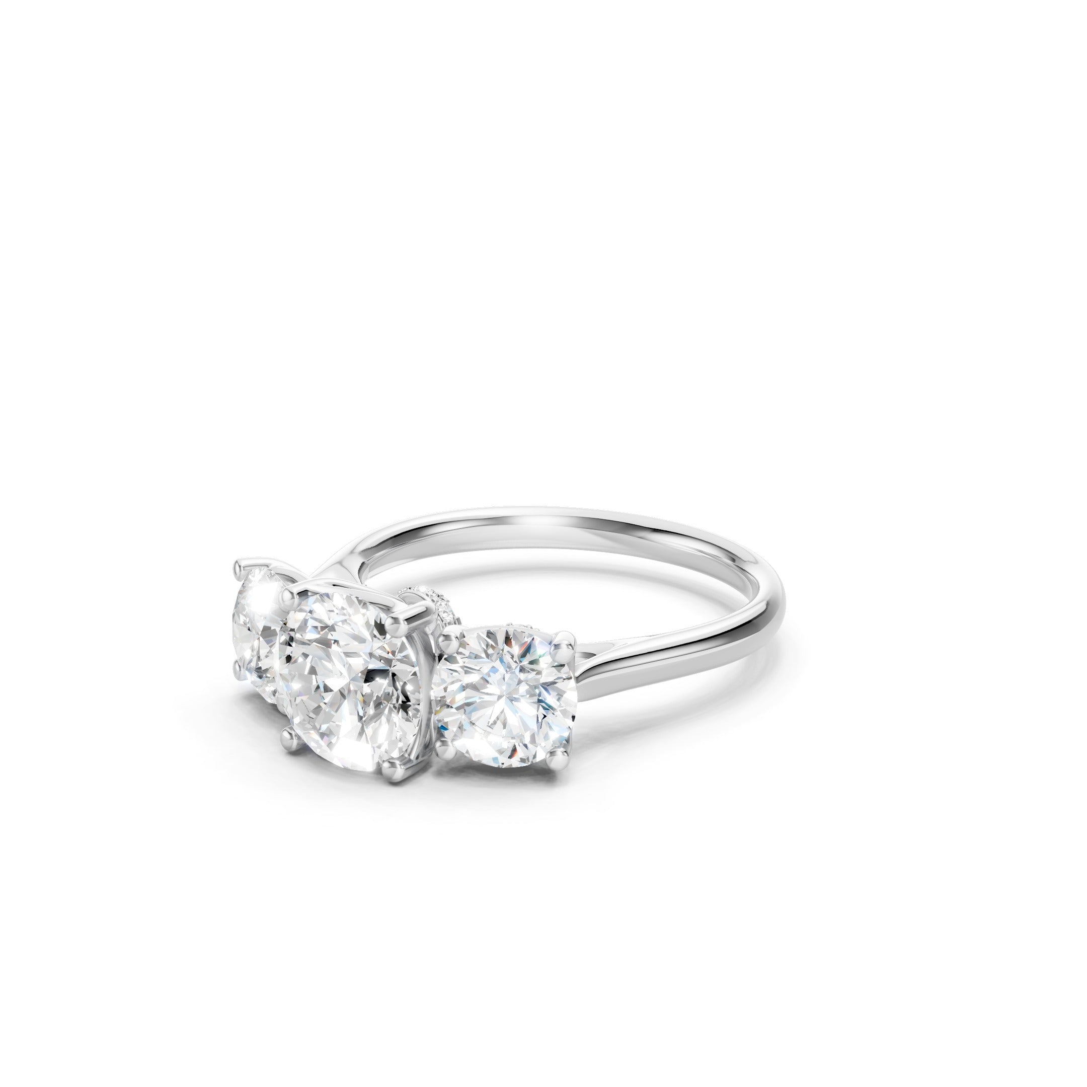 White gold three stone lab grown diamond engagement ring featuring a round cut center diamond, two matching round side diamonds, and a classic prong setting.
