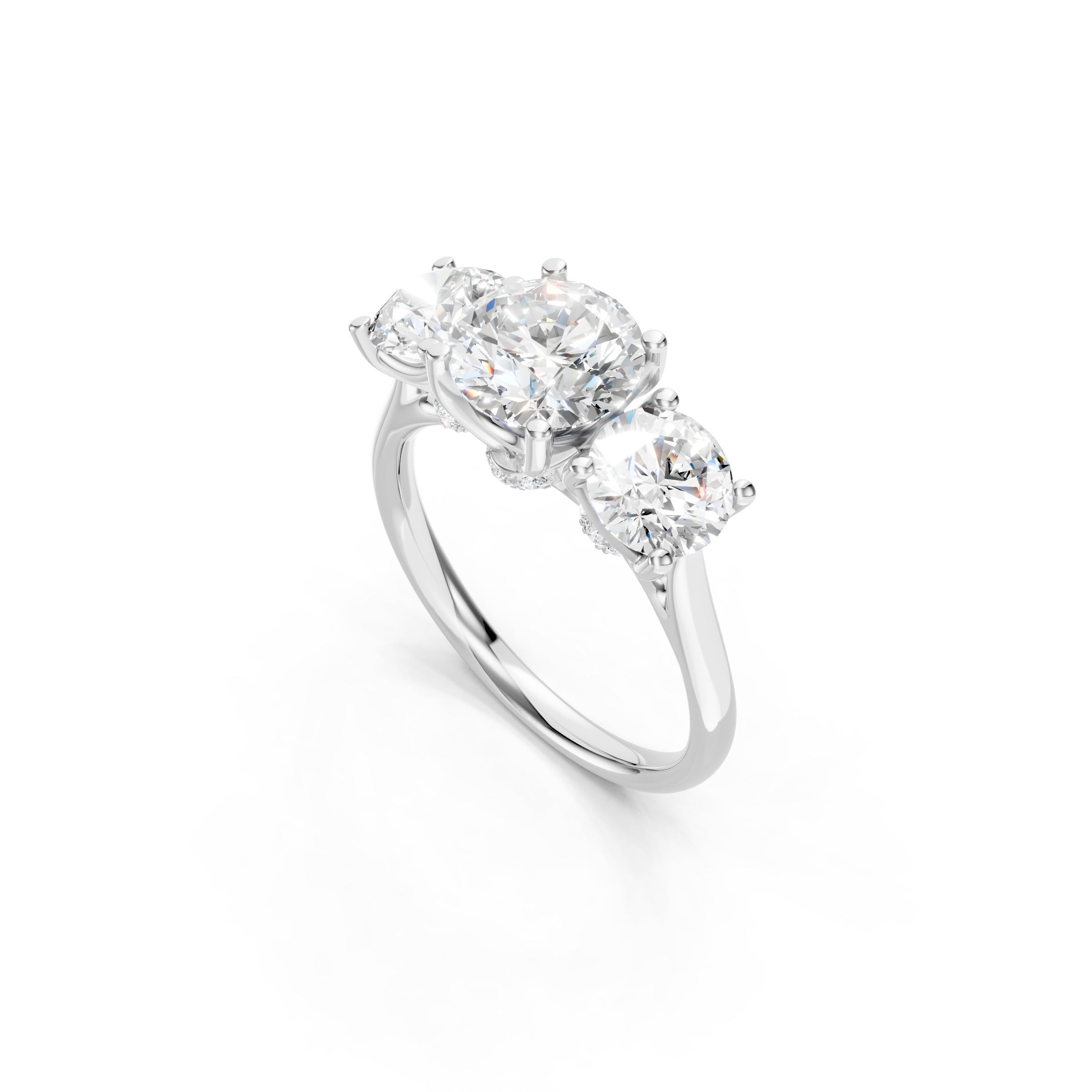 Side view of a solid white gold three stone diamond engagement ring with brilliant round diamonds, secure prong settings, and a polished gold band.