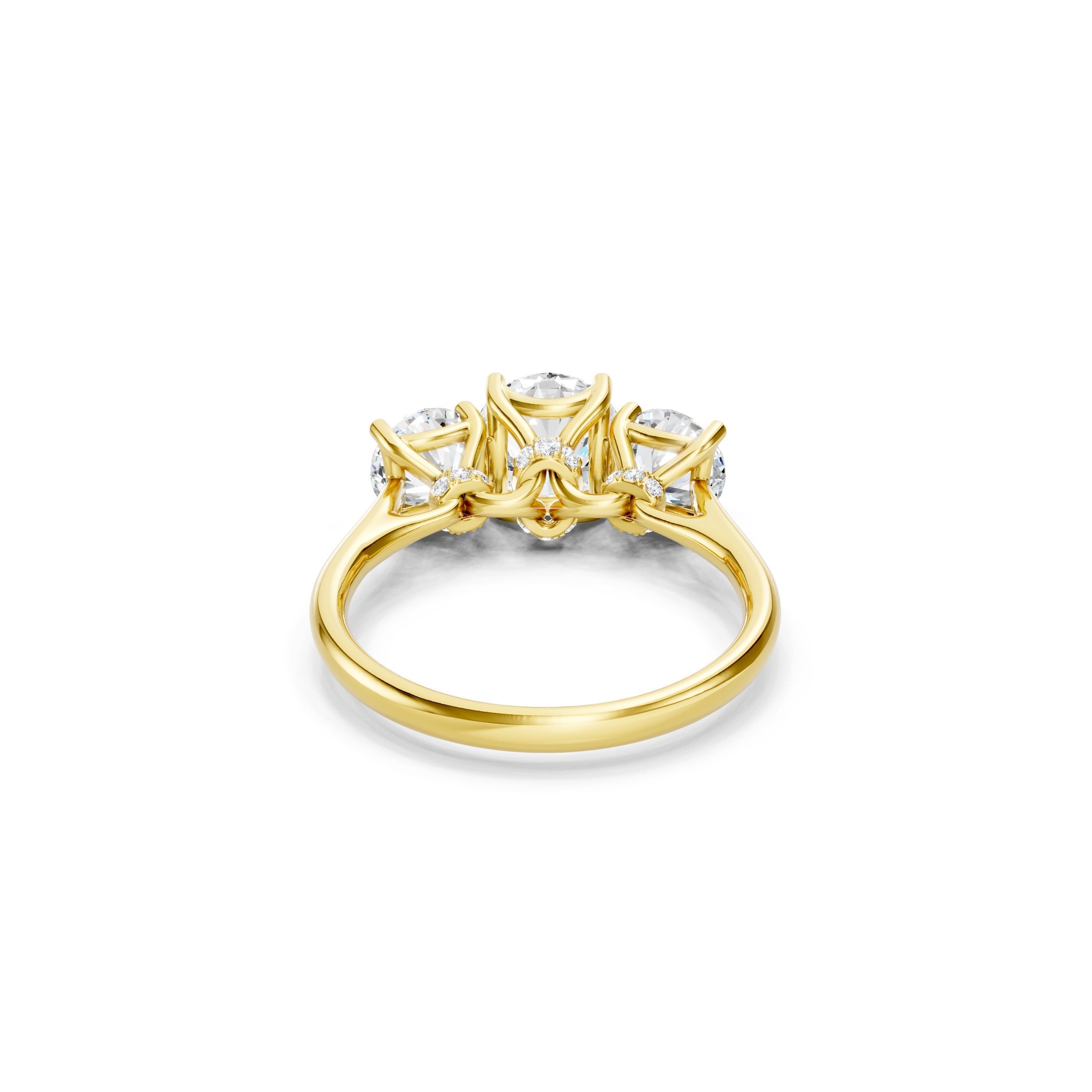 yellow gold three stone engagement ring showing the open gallery, secure diamond prongs, and polished gold band.