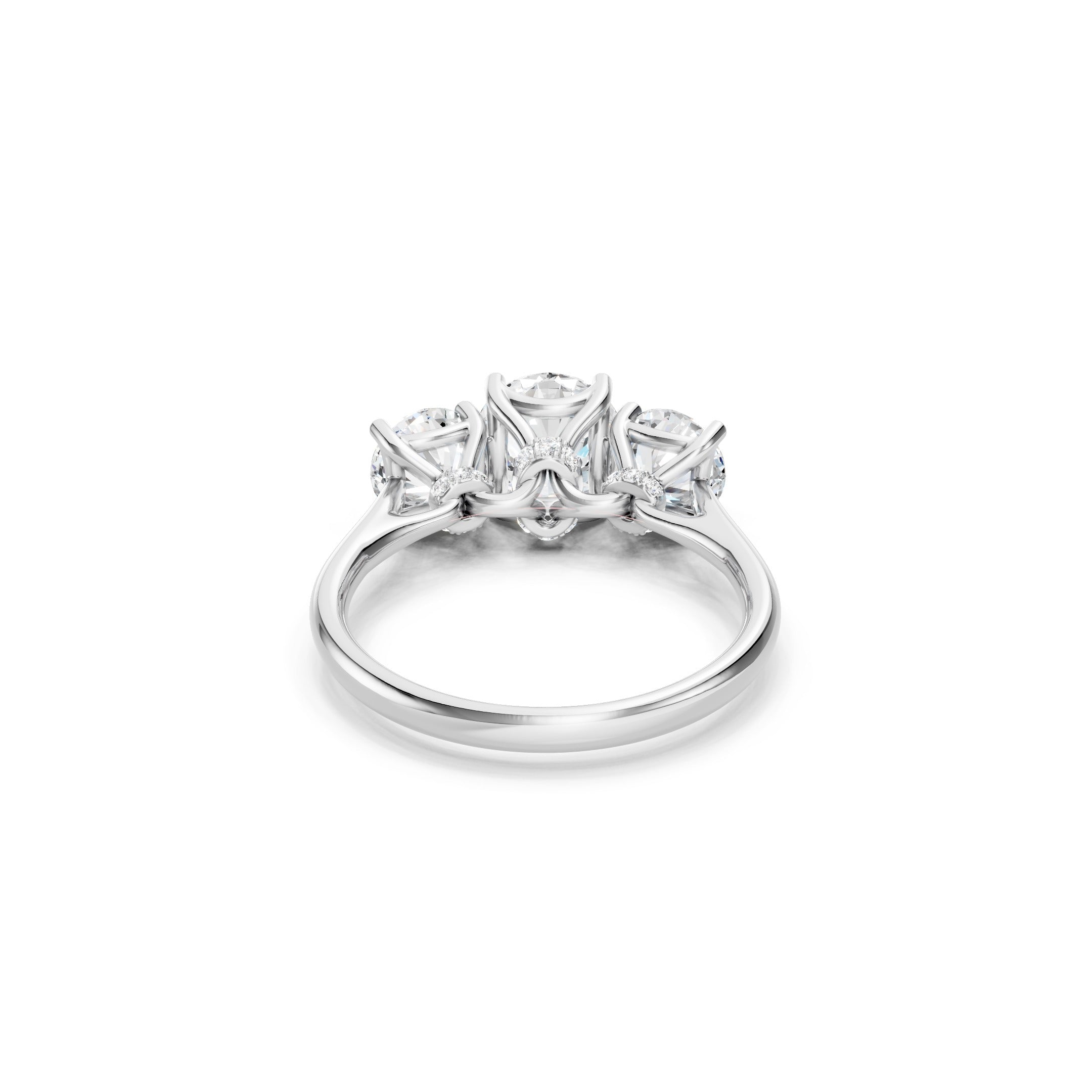 white gold three stone engagement ring showcasing the open gallery, decorative diamond settings, and smooth polished band.