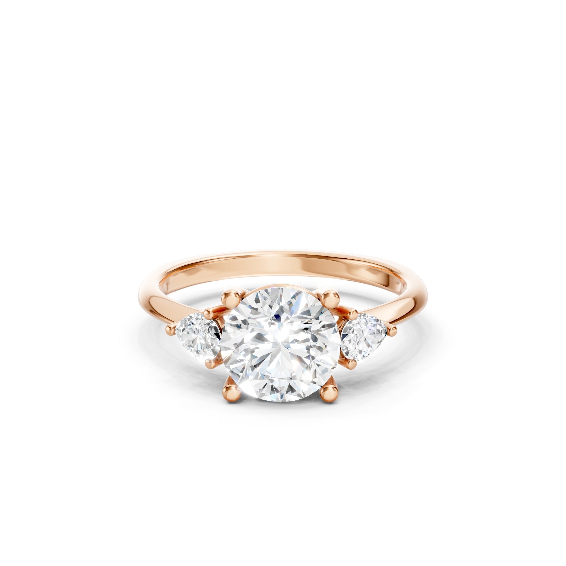 Rose gold three stone lab grown diamond engagement ring featuring a brilliant round center diamond and two pear cut side diamonds in a prong setting, luxury bridal ring for women.