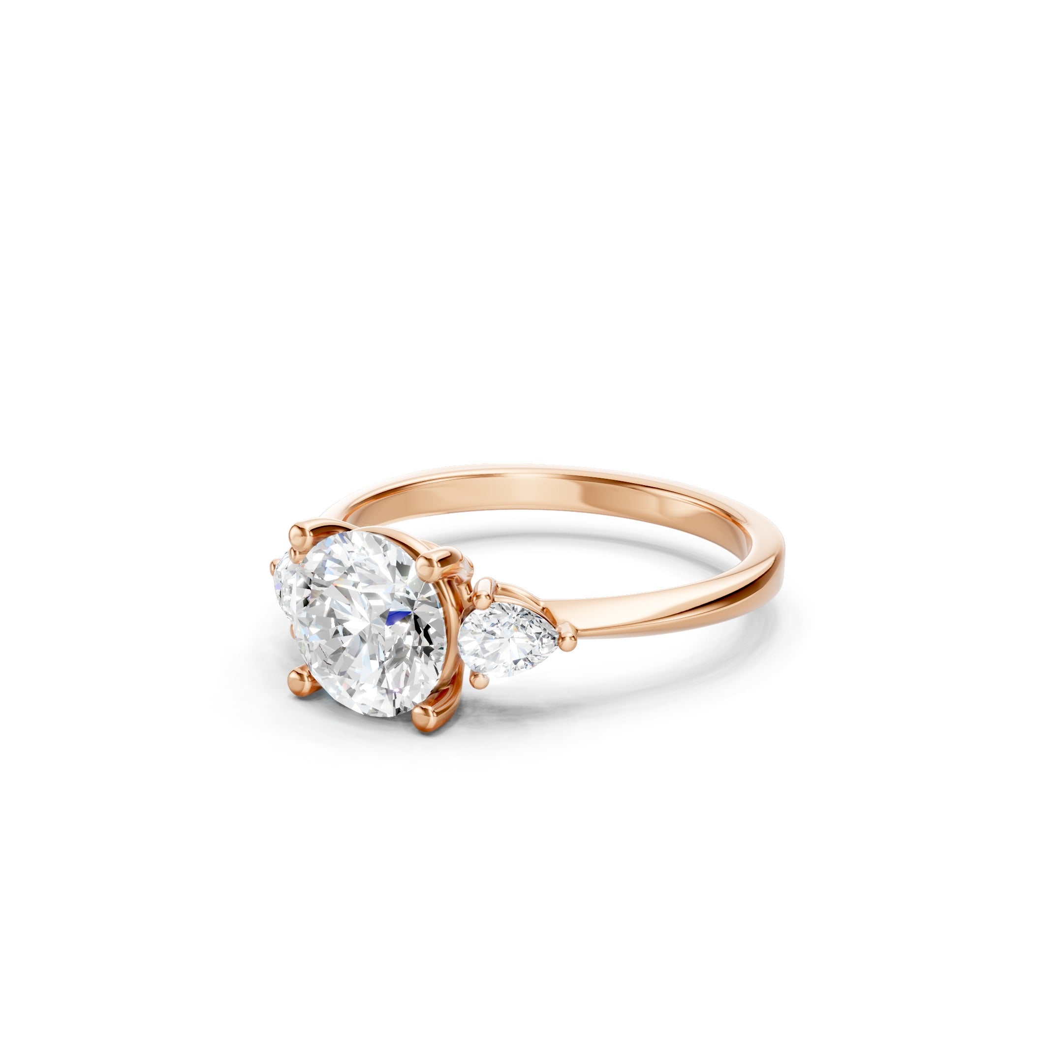 Rose gold three stone lab grown diamond engagement ring featuring a brilliant round center diamond and two pear cut side diamonds in a prong setting, luxury bridal ring for women.
