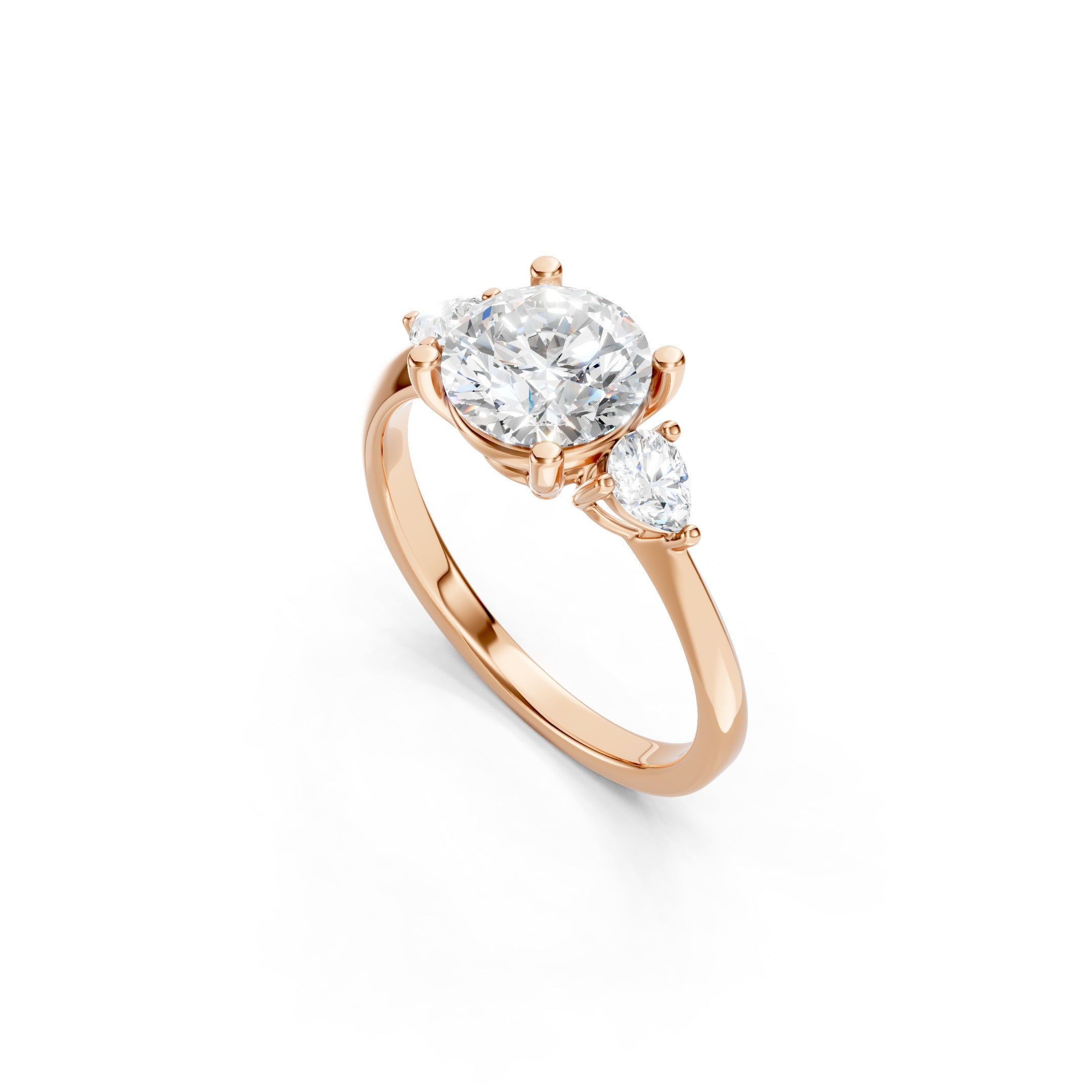 rose gold three stone diamond engagement ring with a large round lab grown diamond, pear shaped side stones, elevated prong setting, and polished gold band.