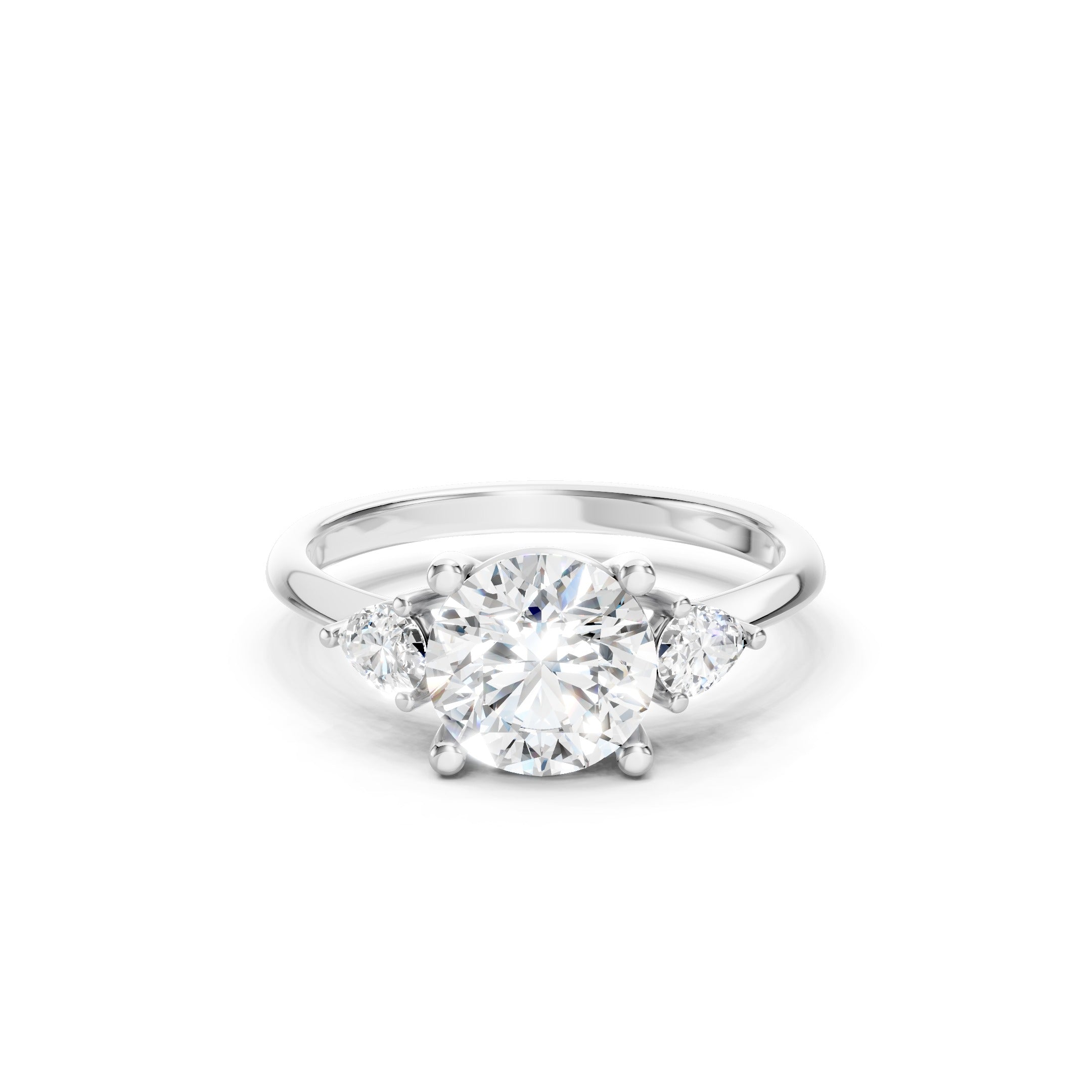 White gold three stone lab grown diamond engagement ring featuring a brilliant round center diamond and two pear cut side diamonds in a prong setting, elegant luxury bridal jewelry.