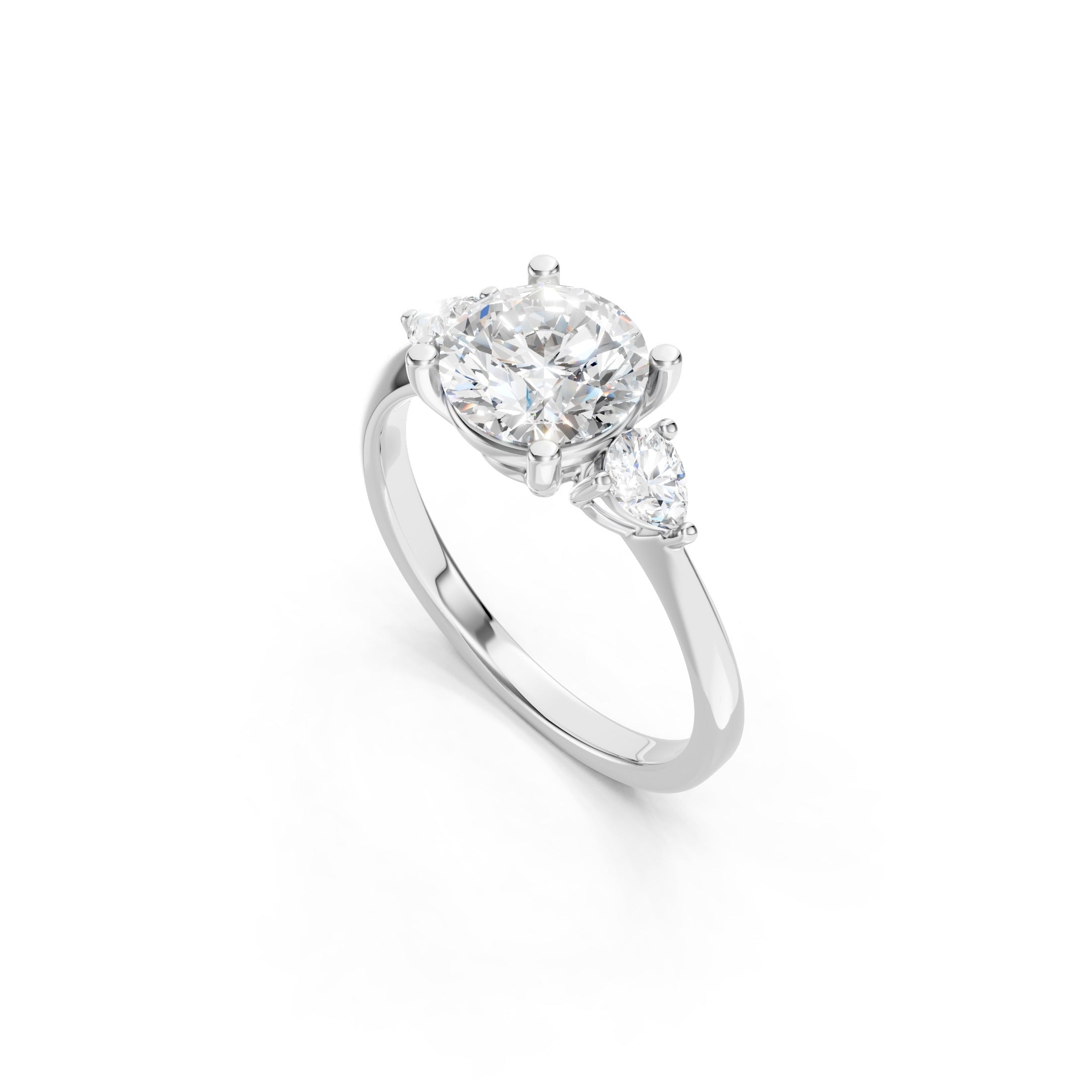 white gold three stone engagement ring with a round lab grown diamond center stone, pear shaped side diamonds, and a polished gold band with prong settings.