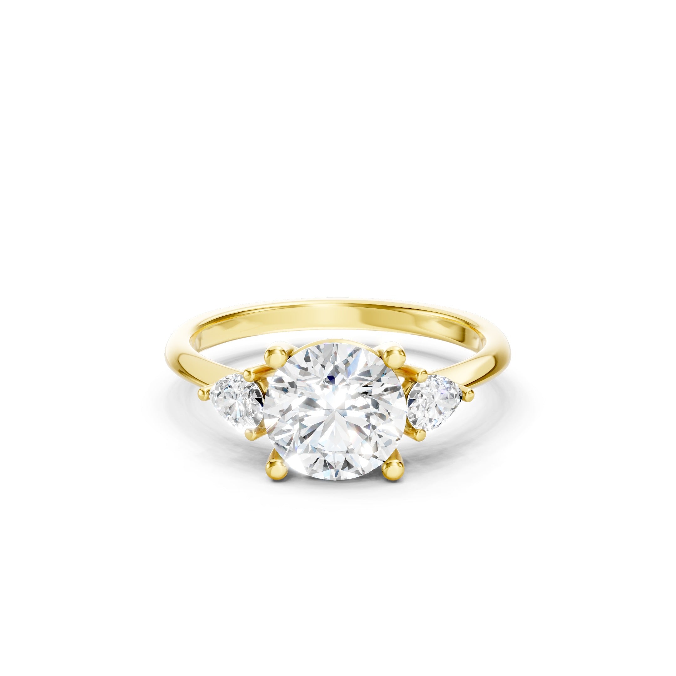 Yellow gold three stone lab grown diamond engagement ring featuring a brilliant round center diamond and two pear cut side diamonds in a prong setting, luxury bridal jewelry.