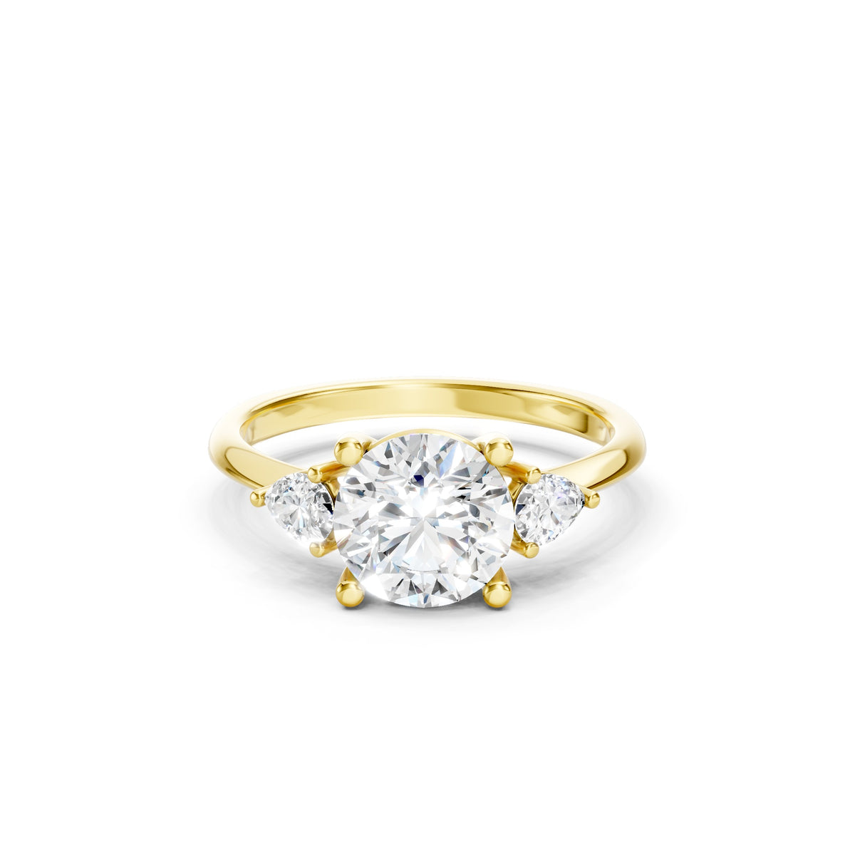 Yellow gold three stone lab grown diamond engagement ring featuring a brilliant round center diamond and two pear cut side diamonds in a prong setting, luxury bridal jewelry.