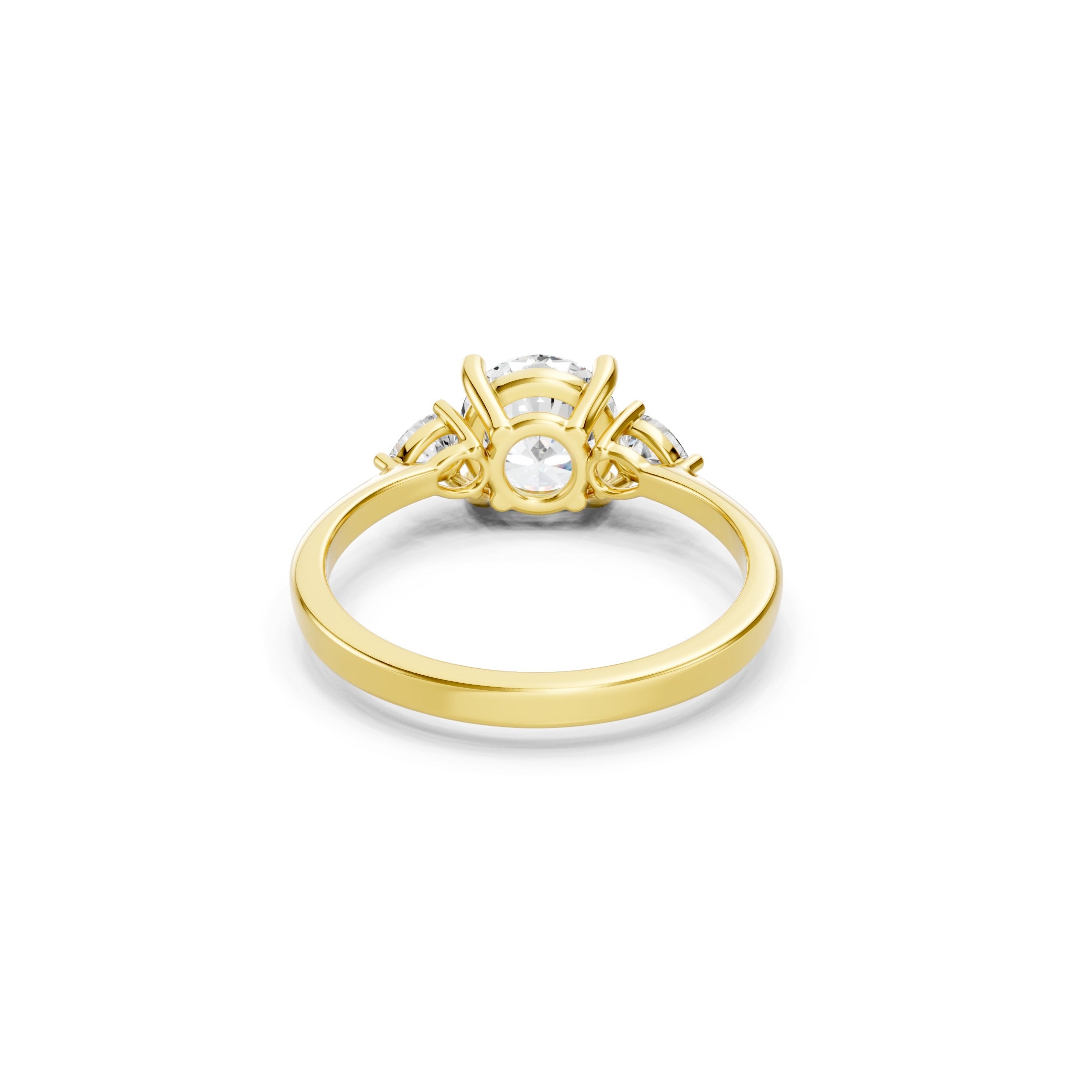 yellow gold three stone lab grown diamond ring showcasing the open gallery setting, prong-secured round and pear cut diamonds, and polished gold band.