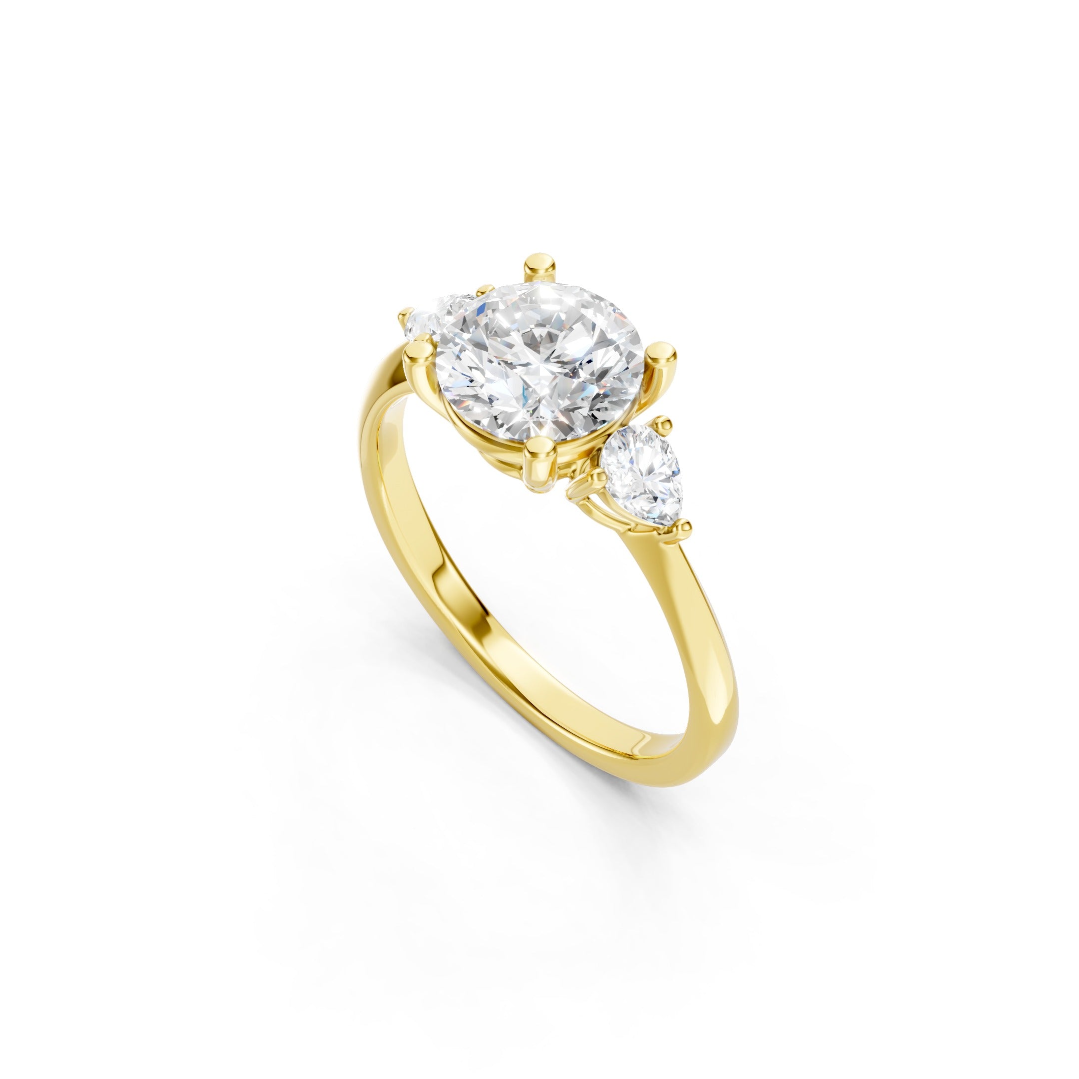 yellow gold three stone engagement ring with a round lab grown diamond center stone, pear shaped side diamonds, and an elegant polished gold band.